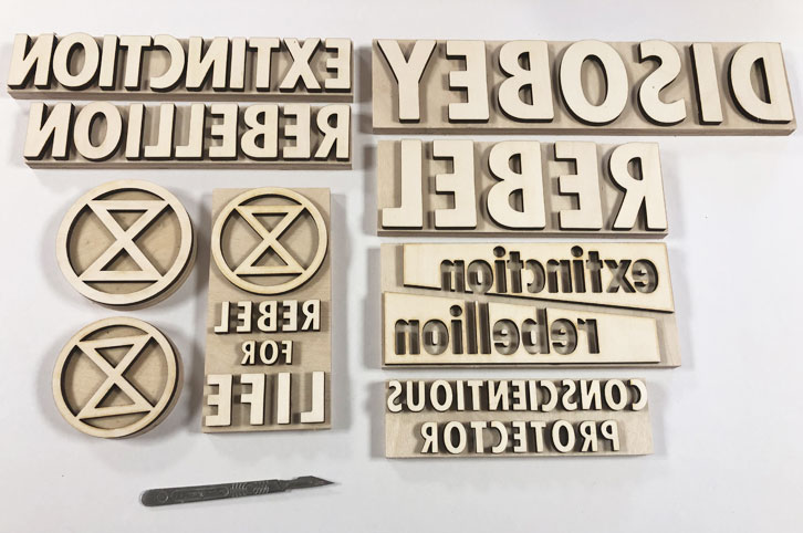 Wood print blocks laser cut for Extinction Rebellion