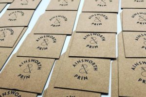Laser cut hand stamped tags on recycled card