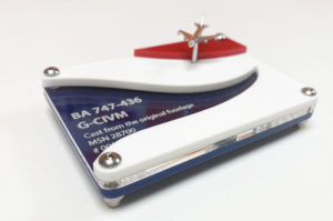 Laser cut acrylic display stand for a model BA airplane. Laser cut from blue, clear, white and red acrylic with model details engraved on the clear acrylic.