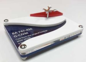 Laser cut acrylic display stand for a model BA airplane. Laser cut from blue, clear, white and red acrylic with model details engraved on the clear acrylic.