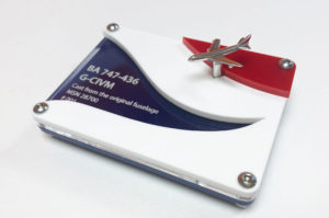 Laser cut acrylic display stand for a model BA airplane. Laser cut from blue, clear, white and red acrylic with model details engraved on the clear acrylic.