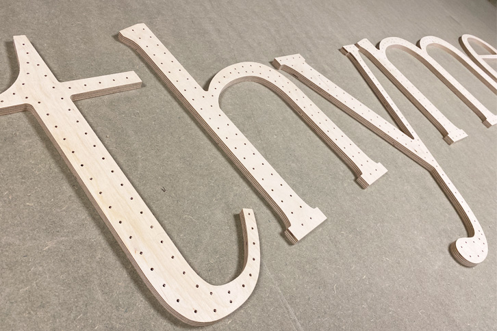 CNC cut large letters cut from 9mm birch plywood.