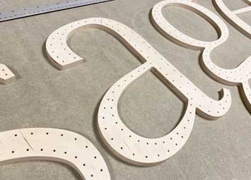 CNC cut large letters cut from 9mm birch plywood.