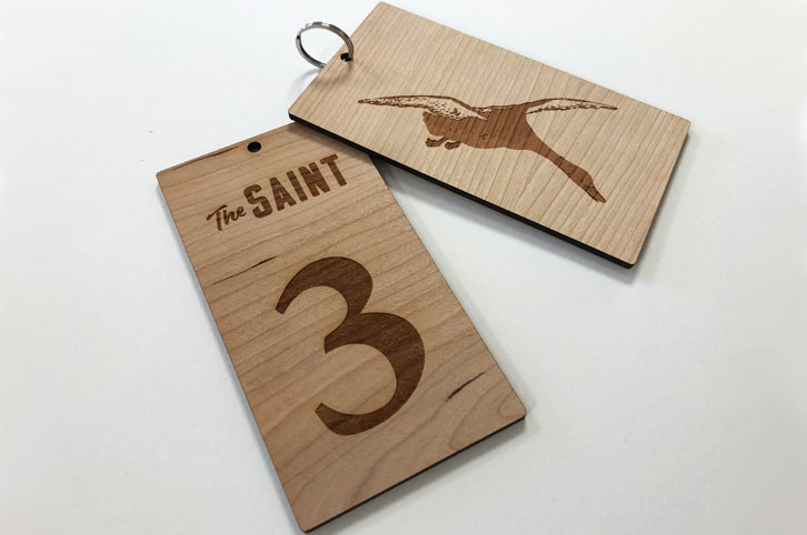 Laser cut and engraved cherry wood keyring fobs for hotel keys. Laser etched with room numbers and hotel logo.