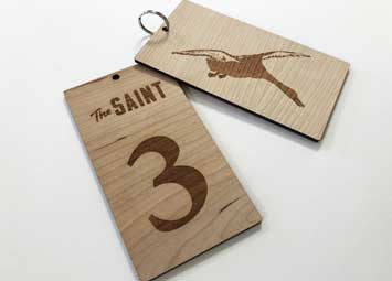 Laser cut and engraved cherry wood keyring fobs for hotel keys. Laser etched with room number, hotel name and duck.