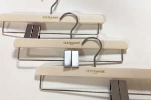Laser engraved wood coat hangers with L'Estrange London logo.