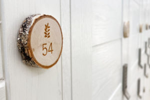 Engraved, natural birch wood slice used as a locker number in Bamfords Wellness Spa.