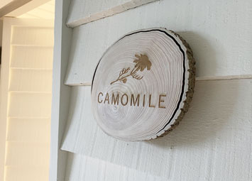 Engraved, natural birch wood slice hanging on a wall..