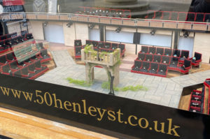 Window display minature model based on the Royal Shakespheare Theatre for 50 Henley Street. Rings are displayed in the model seats. The model shows a scene of Romeo and Juliet.