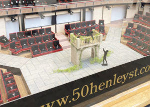 Window display minature model based on the Royal Shakespheare Theatre for 50 Henley Street. Rings are displayed in the model seats. The model shows a scene of Romeo and Juliet.