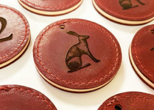 Laser engraved red leather keyfobs with an image of a hare.