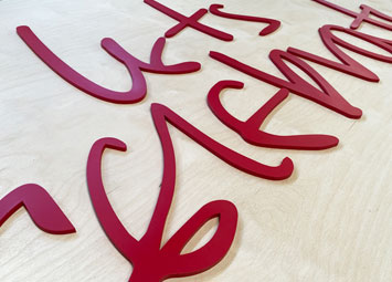 CNC mahined wood sign letters, painted red.