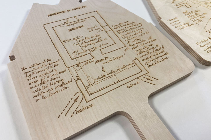 CNC machined wood signs with laser engraved information.