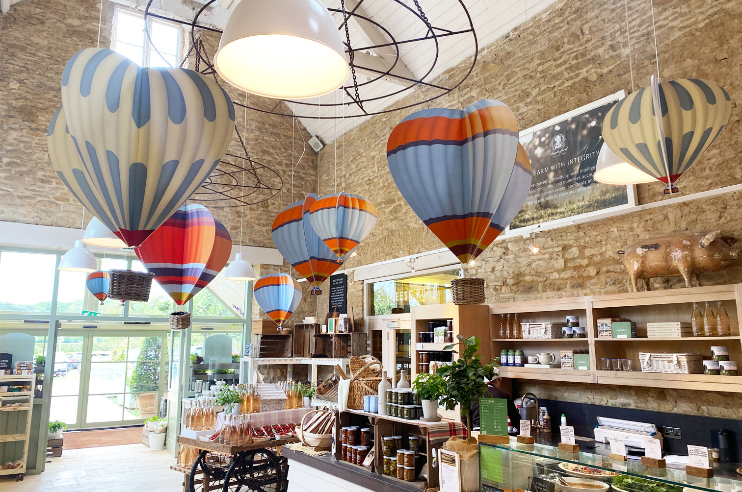 Shop display of wood slot together hanging hot air balloons for Daylesford Farm.