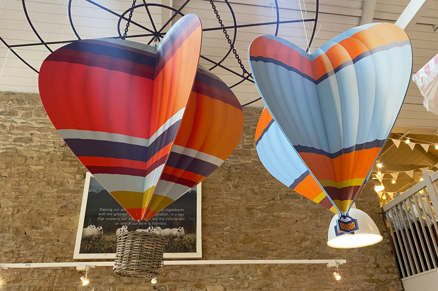 Shop display of wood slot together hanging hot air balloons for Daylesford Farm.