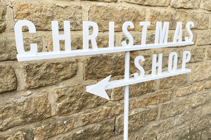 Christmas directional signage, painted wood signs.