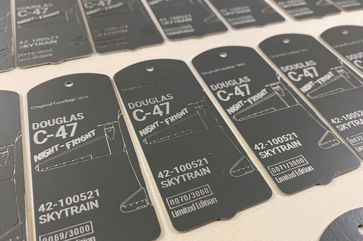 Engraved C-47 aviation tags.